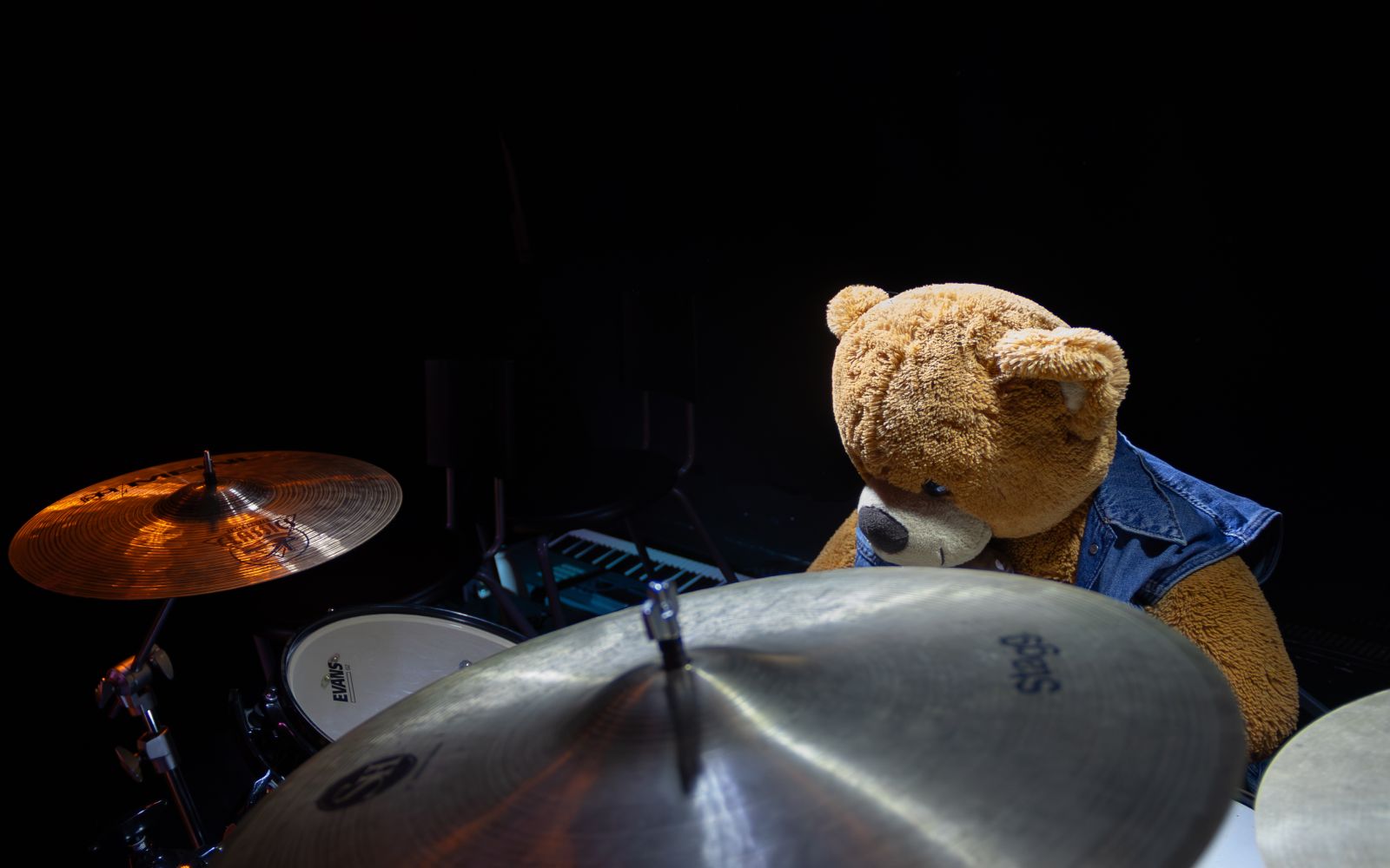 Teddybär am Schlagzeug als kreative Dekoration bei einer Musikveranstaltung.